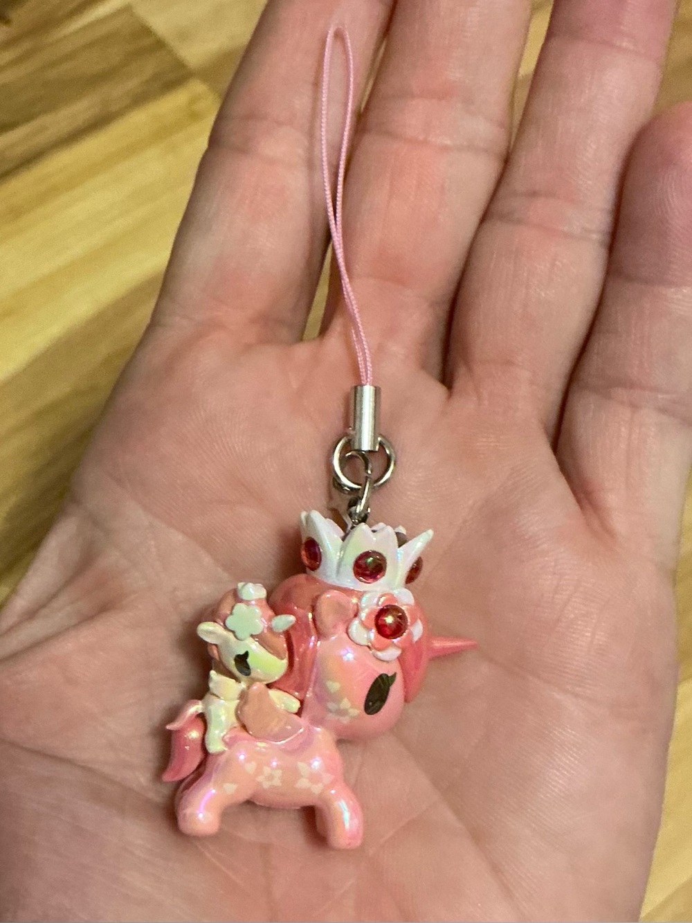 A tokidoki Shimmer Cherry Blossom Unicorno Frenzies phone charm